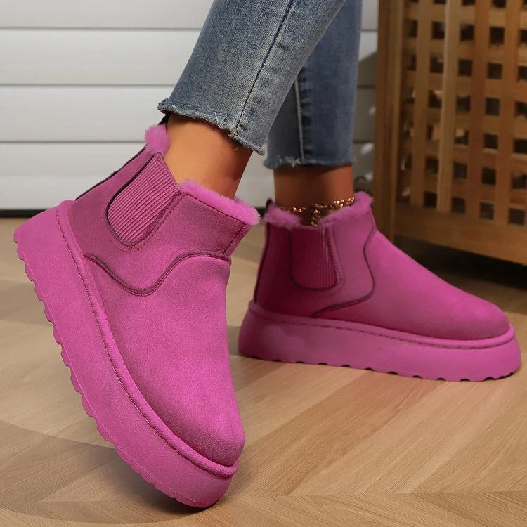 Stylish women's winter snow boots in various colours, featuring a thick sole and plush lining for warmth.
