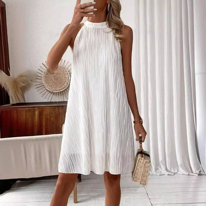 Elegant white backless halter dress with a flattering silhouette and mid-length hemline