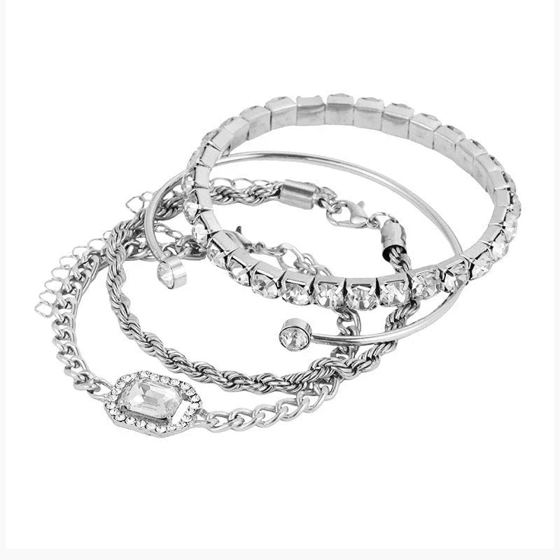 A set of four elegant crystal bracelets with vintage-inspired twisted cuff chains and sparkling rhinestones, perfect for adding a touch of luxury to any outfit.