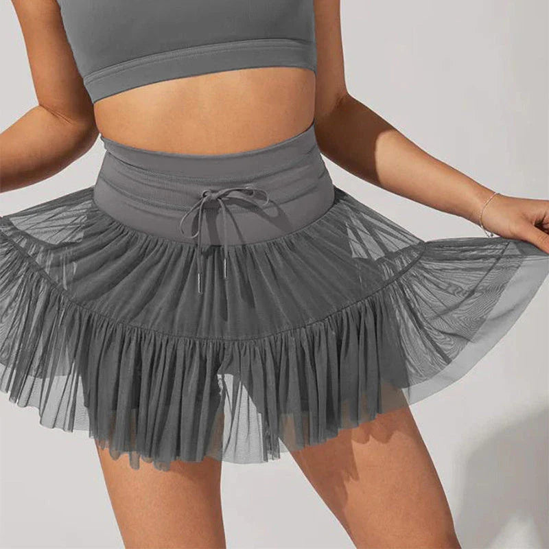 A stylish high-waist lace-up sports skirt with built-in safety shorts in a variety of vibrant colors.