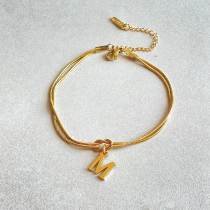 Personalised gold and silver love knot bracelets for couples, perfect as Valentine's Day gifts.