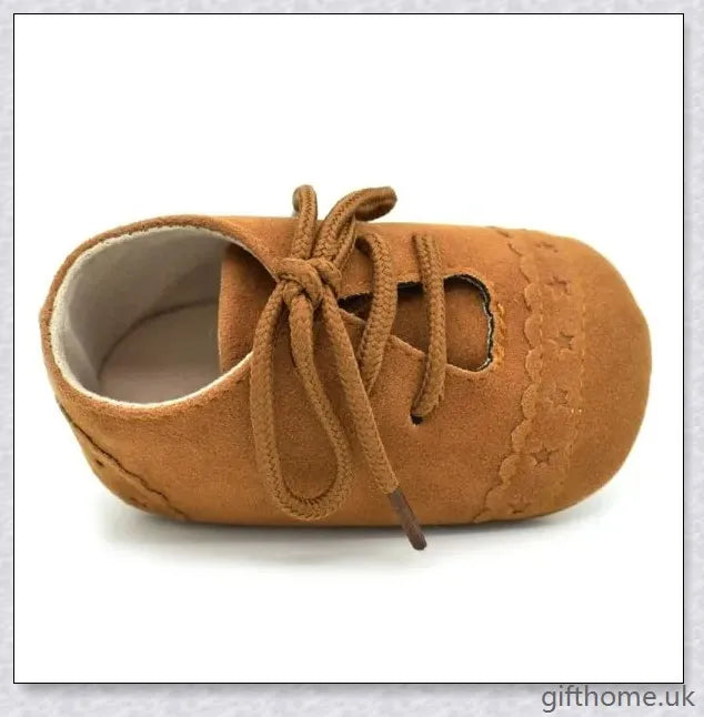 A pair of stylish and comfortable 0-1 year old baby toddler shoes with soft soles in a multicolour design
