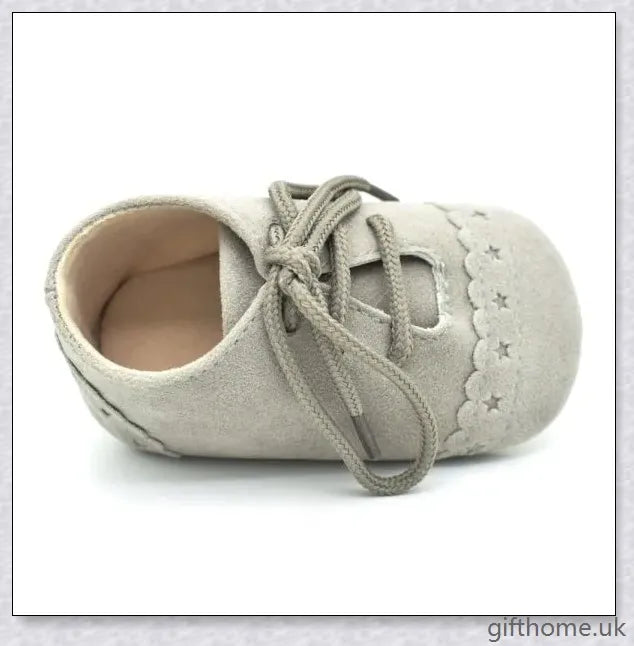 A pair of stylish and comfortable 0-1 year old baby toddler shoes with soft soles in a multicolour design