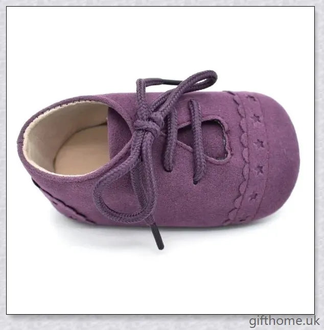 A pair of stylish and comfortable 0-1 year old baby toddler shoes with soft soles in a multicolour design