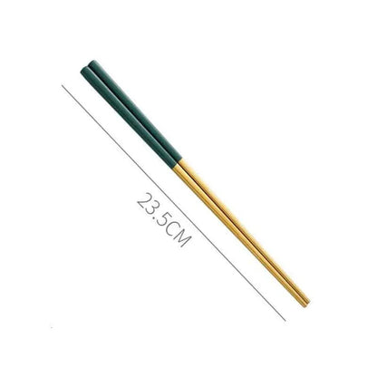 A set of minimalist, eco-friendly tableware in green and gold tones, including plates, bowls, and utensils.
