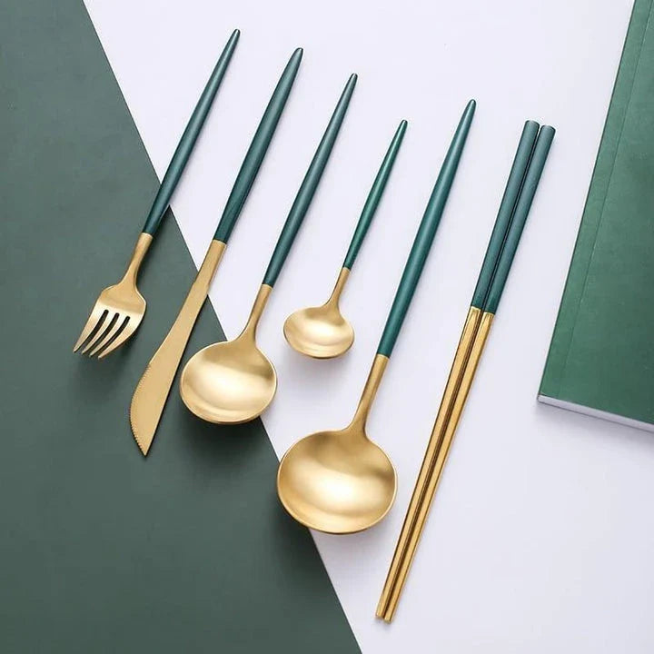 A set of minimalist, eco-friendly tableware in green and gold tones, including plates, bowls, and utensils.