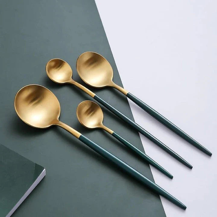A set of minimalist, eco-friendly tableware in green and gold tones, including plates, bowls, and utensils.