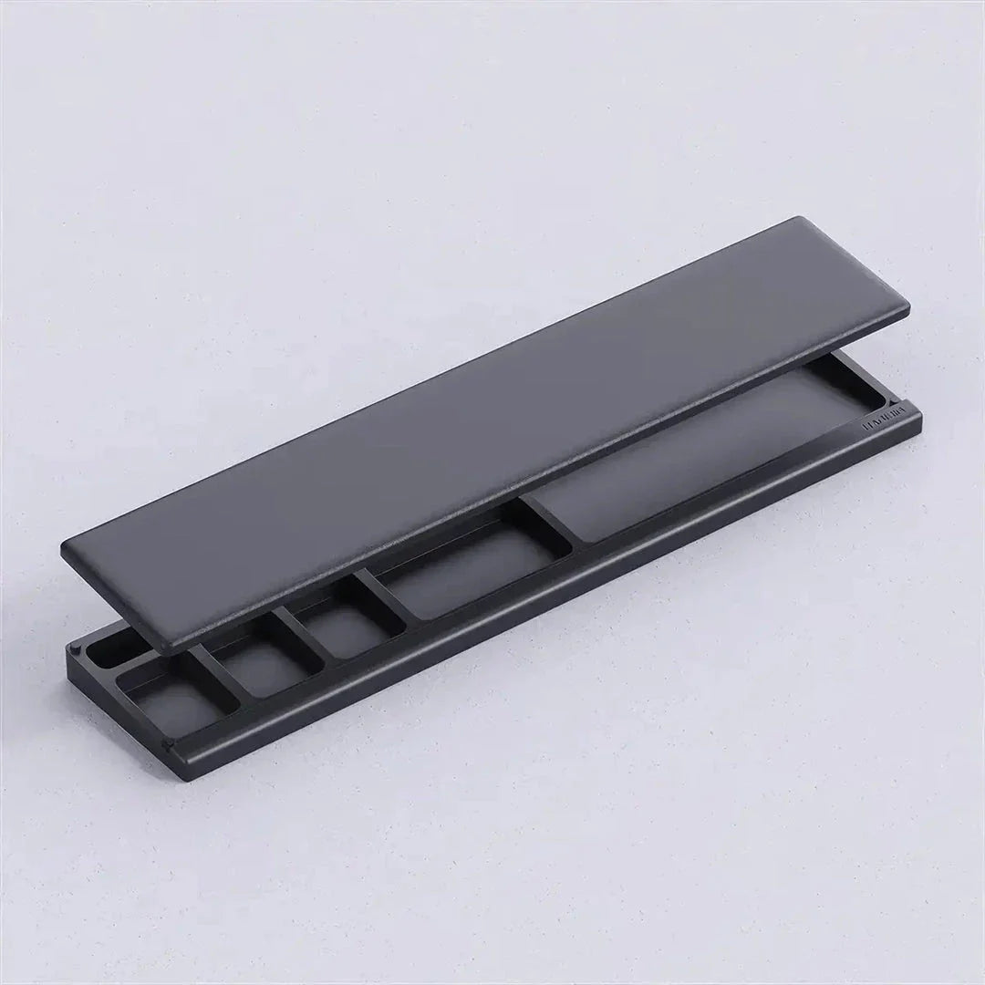 Ergonomic keyboard wrist rest pad with integrated desktop storage for organised workspace