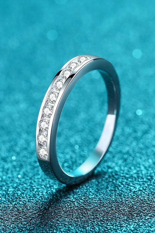 A modern, minimalist 925 sterling silver ring featuring a sparkling moissanite centre stone