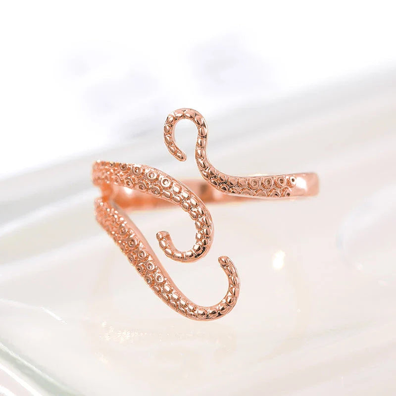 Adjustable octopus tentacle wrap ring made of durable stainless steel with a sleek, elegant design