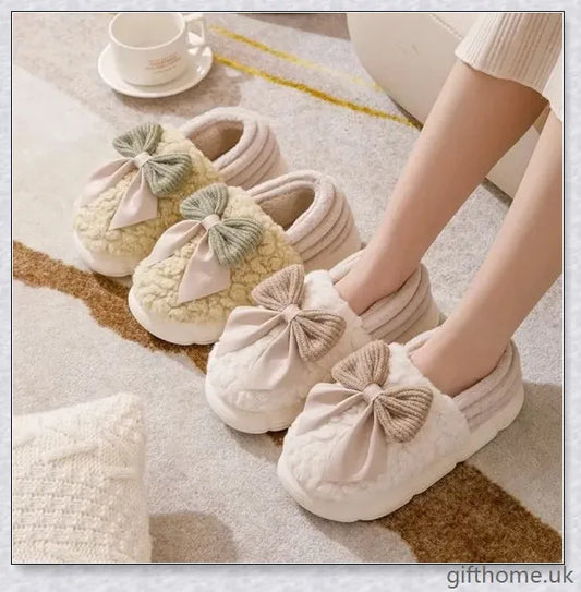 Pair of fluffy, bow-embellished slippers in a soft, suede-like material