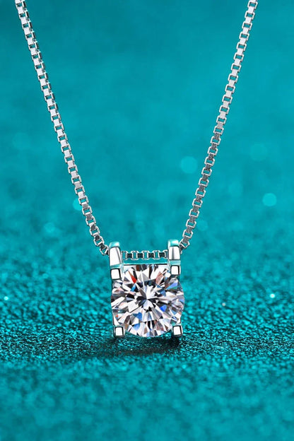 Closeup view of a sparkling 1 carat moissanite gemstone set in a rhodium-plated 925 sterling silver chain necklace