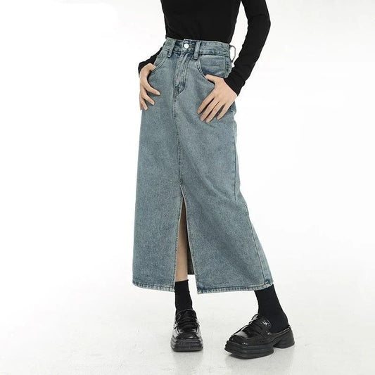 Chic vintage blue denim midi skirt with front slit, featuring a flattering A-line silhouette and stylish distressed details