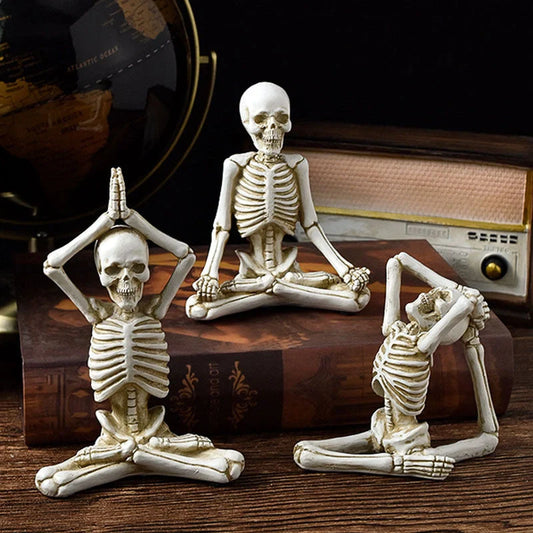 Haunting Halloween desktop ornaments, featuring intricate resin skulls and skeletons in black and vintage white finishes