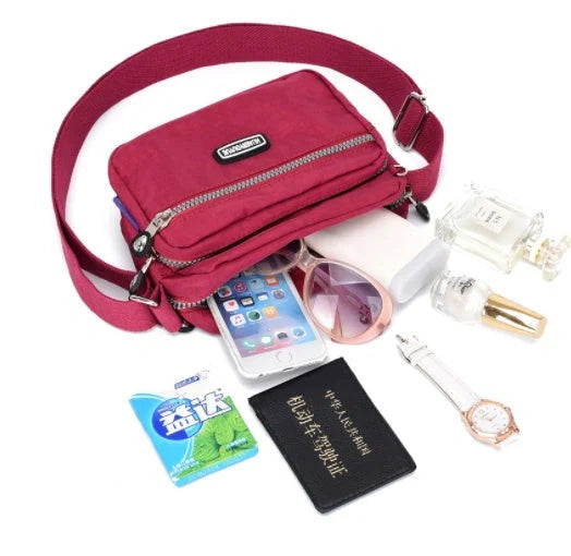 Small square messenger bag in water-repellent nylon with multi-compartment design