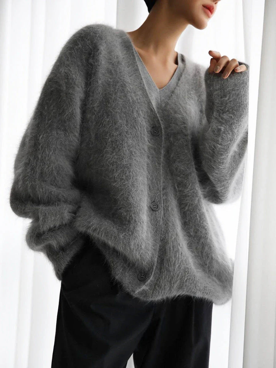 A stylish loose knit cardigan in a variety of colors, featuring a v-neck design and single-breasted closure for a flattering, relaxed fit.