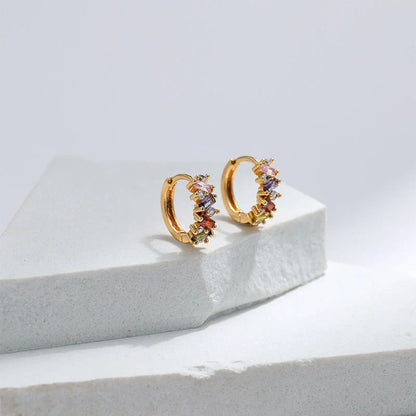 Elegant leaf-patterned ear clips with zircon and emerald gemstones, crafted in premium 18-carat gold-plated copper