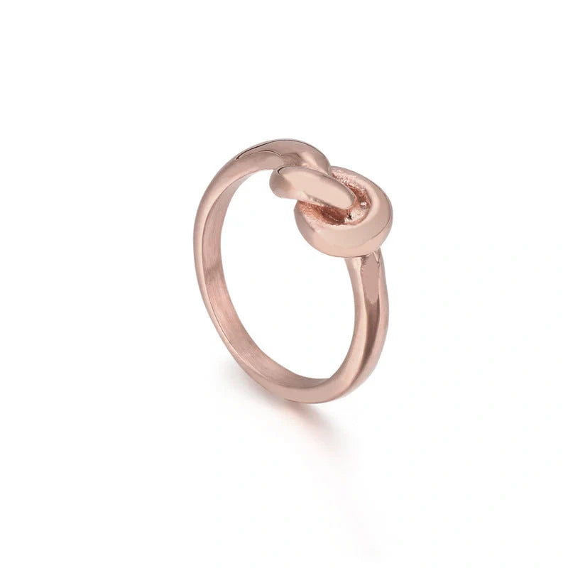 Sleek titanium steel geometric love knot ring in golden and rose gold colours, showcasing a modern and sophisticated design