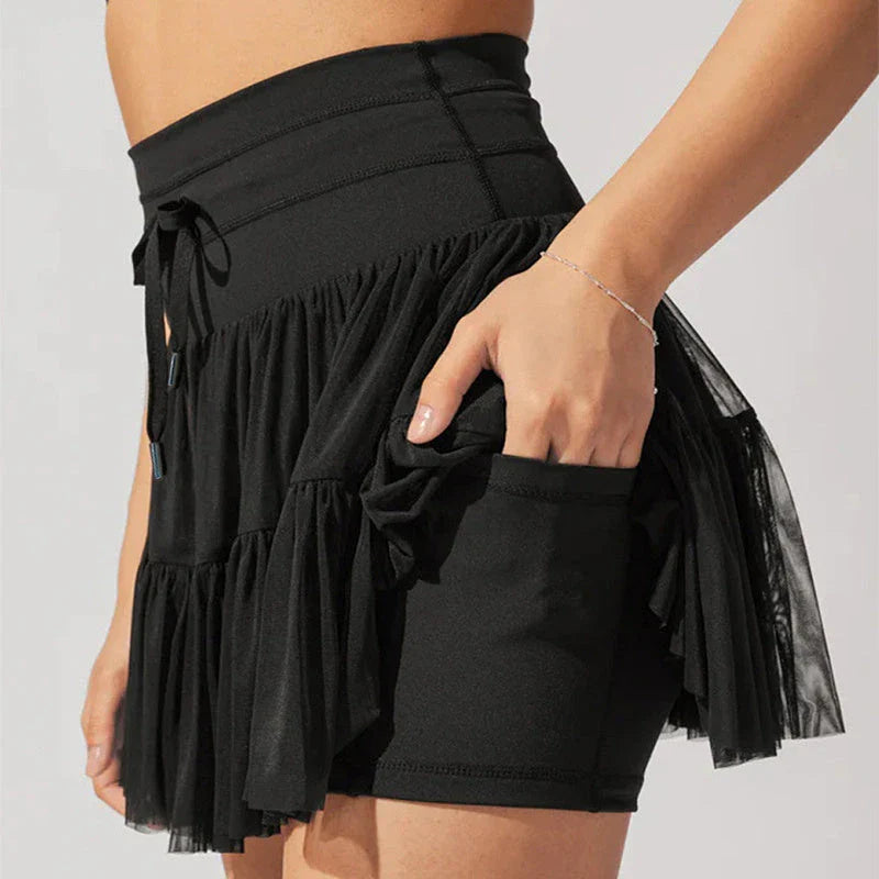 A stylish high-waist lace-up sports skirt with built-in safety shorts in a variety of vibrant colors.
