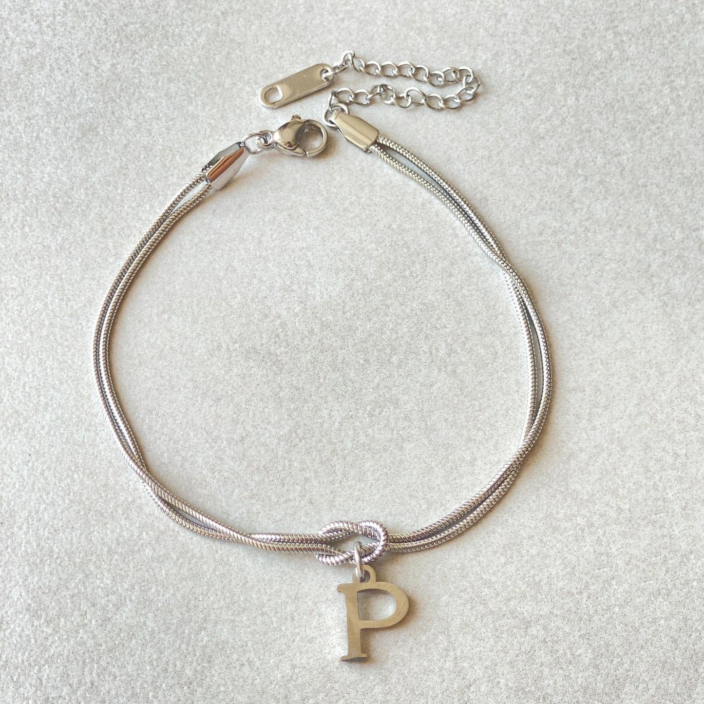 Personalised gold and silver love knot bracelets for couples, perfect as Valentine's Day gifts.