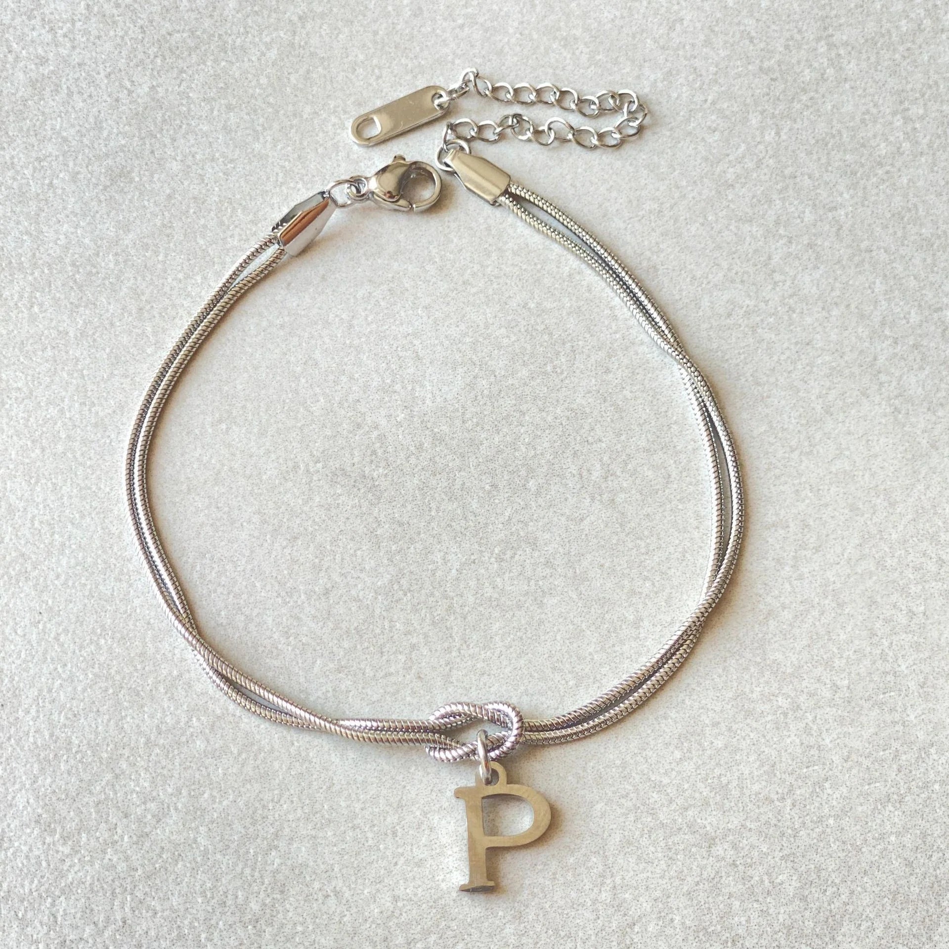 Personalised gold and silver love knot bracelets for couples, perfect as Valentine's Day gifts.