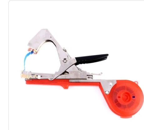 Compact garden hand tool for tying plant stems with plastic tape, measuring 300x200x100mm