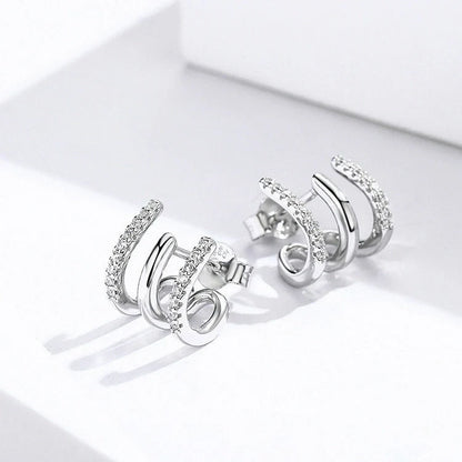 Elegant three-layer sterling silver heart earrings with sparkling gems, perfect for any occasion.