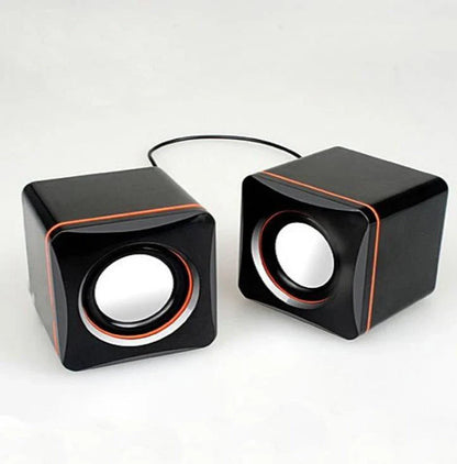 Compact USB-powered desktop speaker with sleek black design and volume control