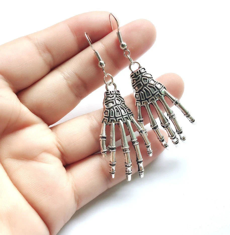 Elegant vintage carved skull and skeleton hands earrings in gold, bronze, and silver finishes