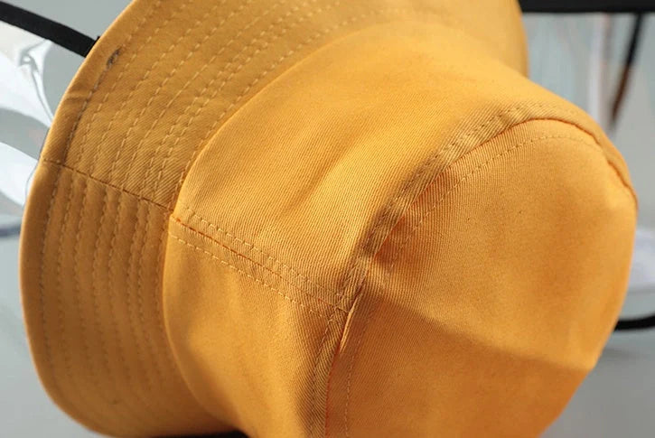Child wearing anti-spitting protective hat with transparent bezel
