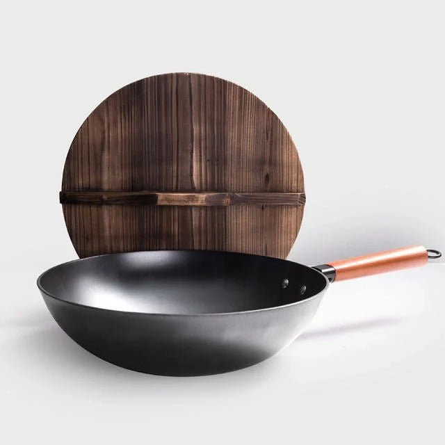 Traditional handmade iron wok with wooden handle and lid