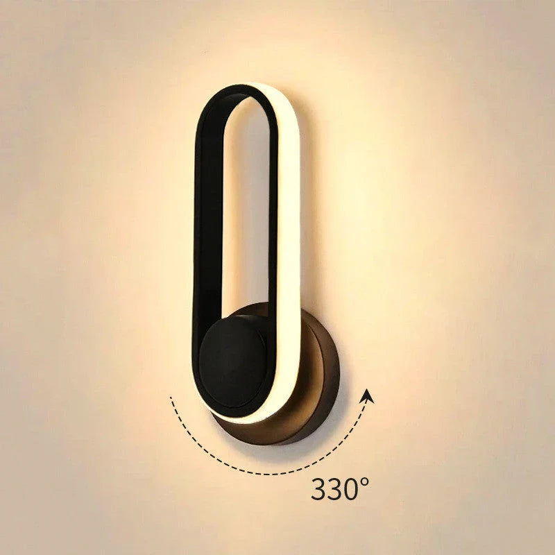 A modern bedside reading wall light with a sleek metal frame and adjustable acrylic shade, providing customisable ambient lighting for a British bedroom.