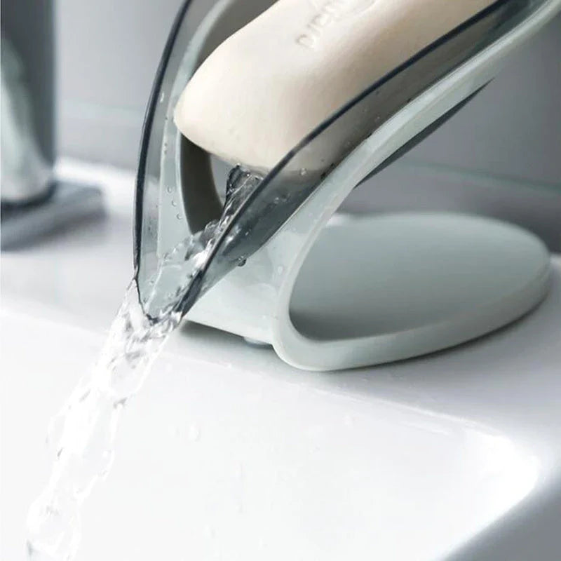 Elegant leaf-shaped soap dish with self-draining design and stable triangular shape, made of durable ABS material