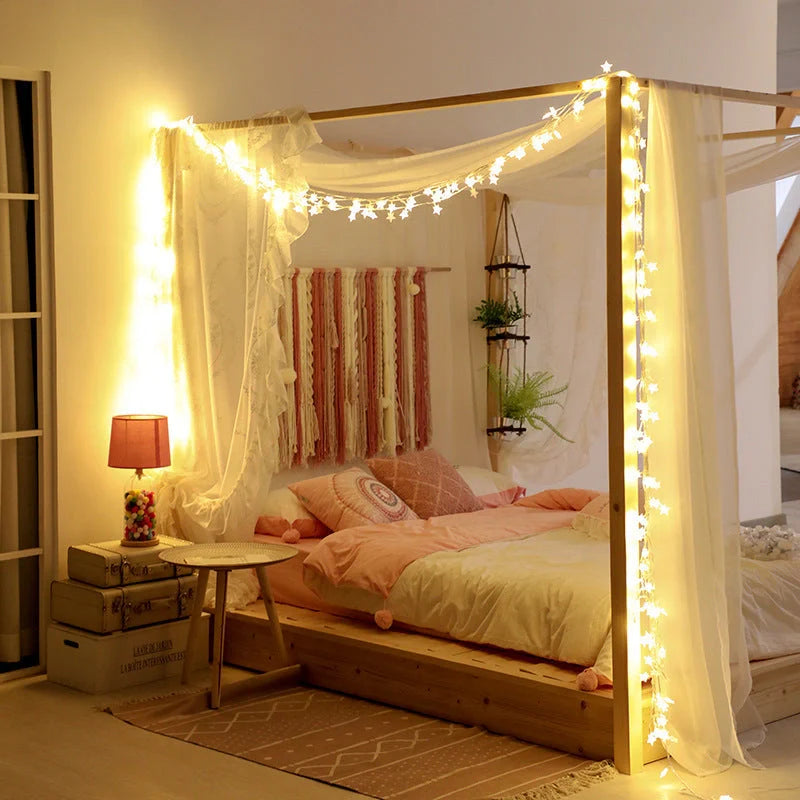 Battery-operated LED curtain garland with plastic stars and fur balls for festive decoration