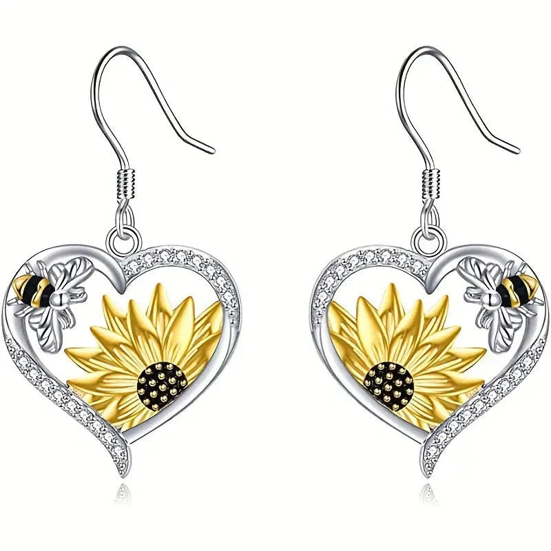 Elegant silver earrings featuring delicate bee and sunflower motifs, a stunning fashion accessory with natural charm.