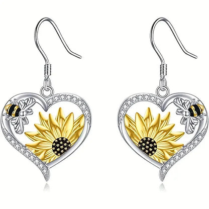 Elegant silver earrings featuring delicate bee and sunflower motifs, a stunning fashion accessory with natural charm.