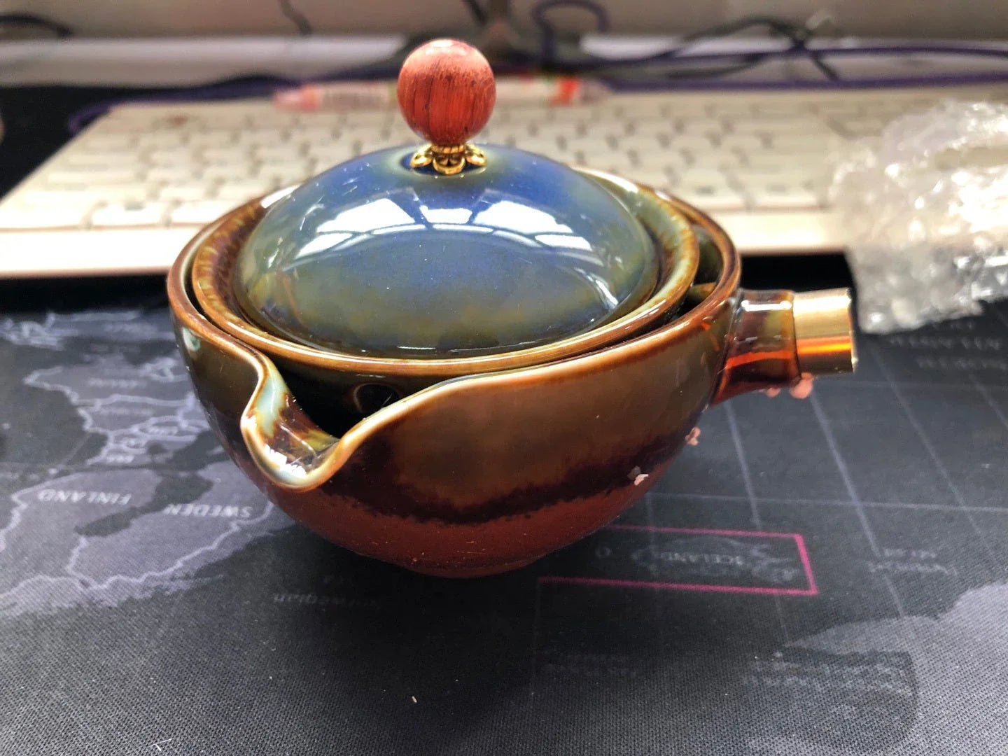 Handcrafted ceramic teapot with wooden handle, designed for brewing traditional Oolong tea with enhanced flavour and aroma