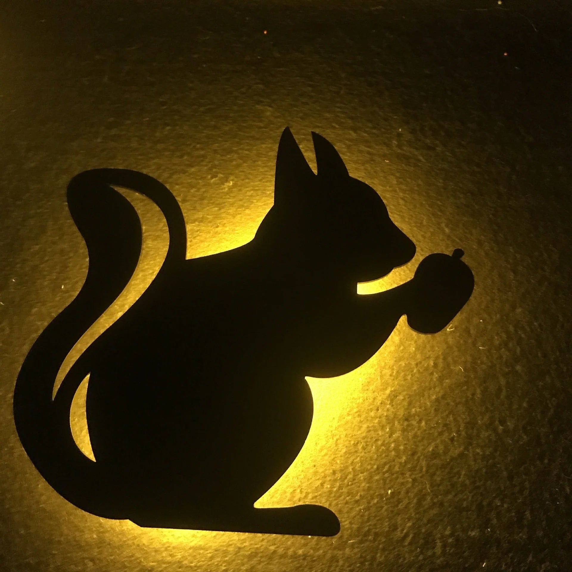 A stylish cat-shaped smart sensor night light that automatically illuminates a room when motion is detected, creating a warm and cozy atmosphere.
