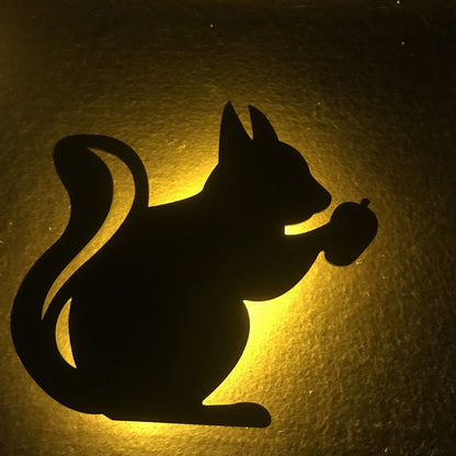 A stylish cat-shaped smart sensor night light that automatically illuminates a room when motion is detected, creating a warm and cozy atmosphere.