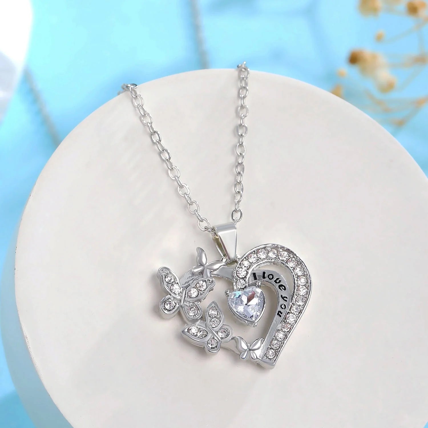 Butterfly Love Necklace with rhinestones and hollow heart-shaped pendant in white, purple, or pink