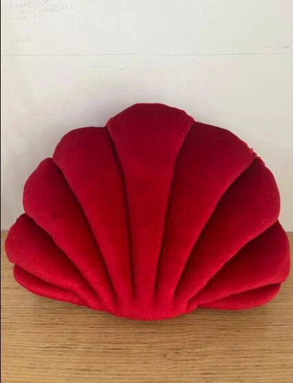 Cosy shell-shaped plush nap pillow in various colours and sizes for ultimate comfort