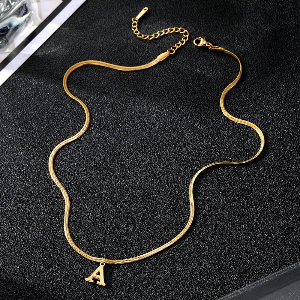 Gold-coloured A-Z letter pendant necklace on a snake chain