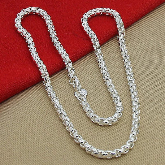 Silver-plated round pendant necklace with secure clasp, showcasing elegant British-inspired design