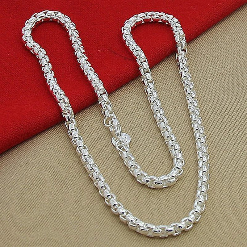 Silver-plated round pendant necklace with secure clasp, showcasing elegant British-inspired design