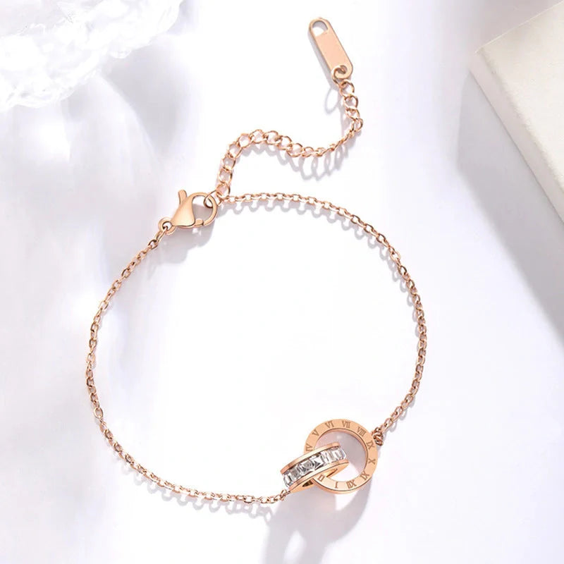 Rose gold titanium steel bracelet with zircon inlay and roman numeral detailing