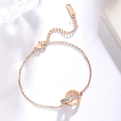 Rose gold titanium steel bracelet with zircon inlay and roman numeral detailing