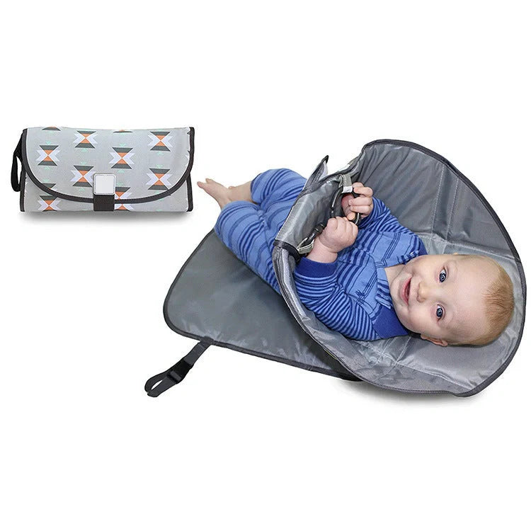 Portable diaper changing pad clutch with built-in toy ring, foldable design for easy transport