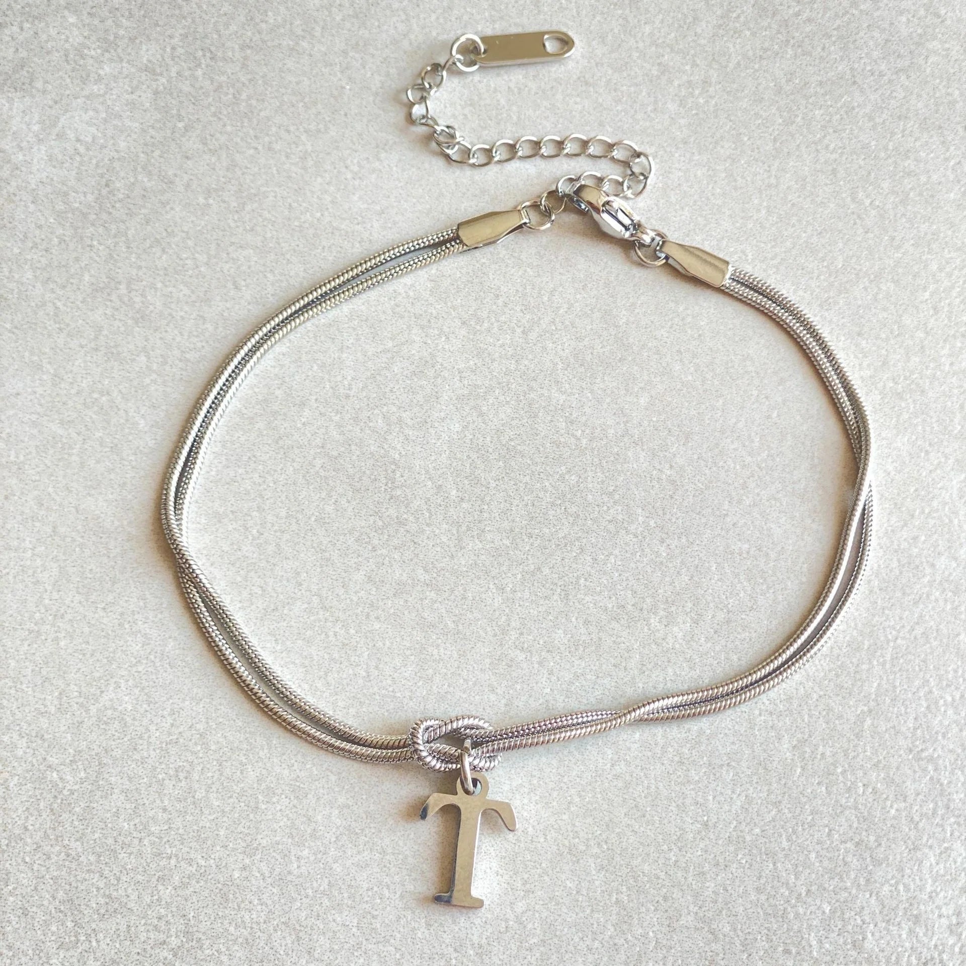 Personalised gold and silver love knot bracelets for couples, perfect as Valentine's Day gifts.