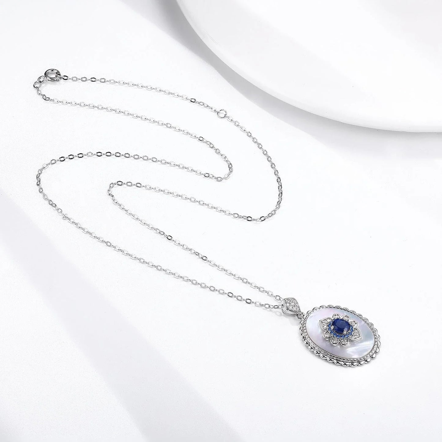 Elegant sterling silver pendant necklace with sparkling sapphires and diamonds, perfect for fashion-forward women