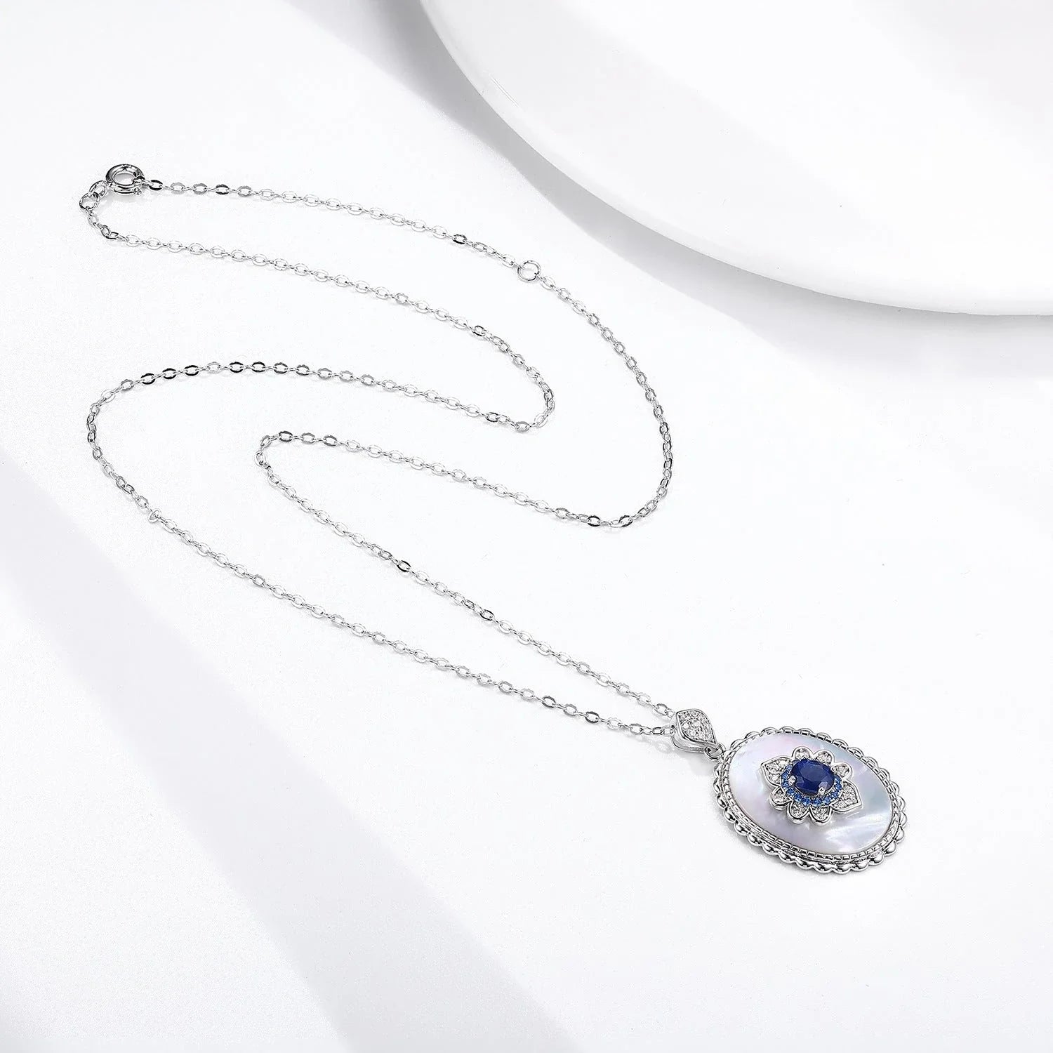 Elegant sterling silver pendant necklace with sparkling sapphires and diamonds, perfect for fashion-forward women
